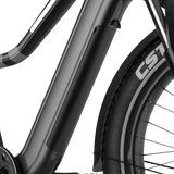 Close-up image of the 26" Step Over Electric Mountain Bike's battery pack, seamlessly integrated into the frame. The Evolvate Pro bike showcases a sleek, modern design with a black finish and customizable lighting bar. The tire is visible, bearing the branding "CST.