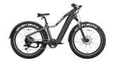 The Evolvate Pro 26" Step Over Electric Mountain Bike - Black is a sleek, black bike equipped with thick, knobby tires labeled "CST BFT 26x4.0." This versatile bike features a sturdy frame, a front suspension fork, disc brakes, an integrated swappable battery design, and a comfortable saddle, making it ideal for both off-road and urban riding.