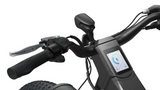 Close-up of the handlebar of the Evolvate Pro 26" Step Over Electric Mountain Bike - Black, showcasing a control screen that indicates speed and battery life, a throttle grip, brake lever, and handlebar grips. The bike is equipped with a BAFANG rear hub motor and features wide, grippy tires visible at the lower left corner of the image.