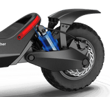 A close-up view of the rear wheel and suspension system of the Evolvate Pro Panther ES800 Super Electric Scooter. The blue suspension spring is prominently visible, and the tire features a textured tread designed for off-road use. The sleek body of the Panther ES800 sports a black and gray color scheme and is equipped with dual 3000W motors, allowing for speeds up to 37.3 MPH with a range of 31 miles.